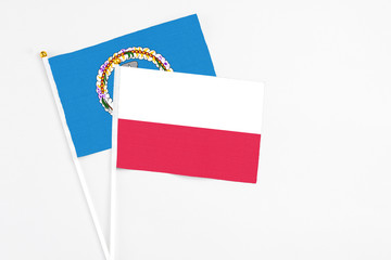 Poland and Northern Mariana Islands stick flags on white background. High quality fabric, miniature national flag. Peaceful global concept.White floor for copy space.