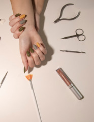 Autumn manicure with brushes in salon.