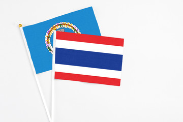 Thailand and Northern Mariana Islands stick flags on white background. High quality fabric, miniature national flag. Peaceful global concept.White floor for copy space.