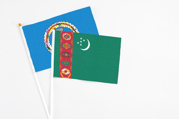Turkmenistan and Northern Mariana Islands stick flags on white background. High quality fabric, miniature national flag. Peaceful global concept.White floor for copy space.