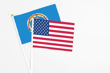 United States and Northern Mariana Islands stick flags on white background. High quality fabric, miniature national flag. Peaceful global concept.White floor for copy space.