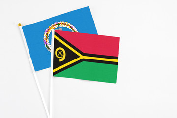 Vanuatu and Northern Mariana Islands stick flags on white background. High quality fabric, miniature national flag. Peaceful global concept.White floor for copy space.