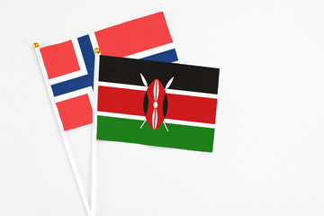 Kenya and Norway stick flags on white background. High quality fabric, miniature national flag. Peaceful global concept.White floor for copy space.