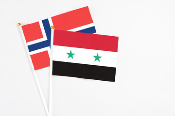 Syria and Norway stick flags on white background. High quality fabric, miniature national flag....