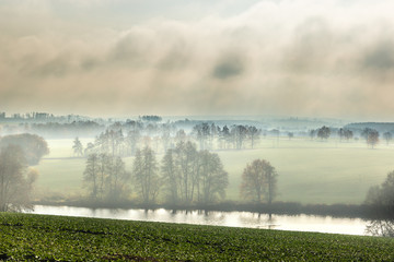 Autumn scenery. Countryside, fields, forests in the morning fog. Czech Republic.