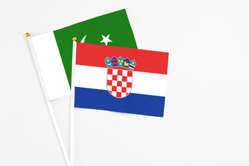 Croatia and Pakistan stick flags on white background. High quality fabric, miniature national flag....