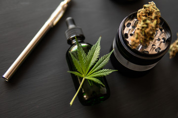 CBD cannabis OIL close up, Cannabis on black background. Product of marijuana. Electronic marijuana...
