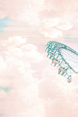 Collage. Abstract image of a ferris wheel in the air clouds.