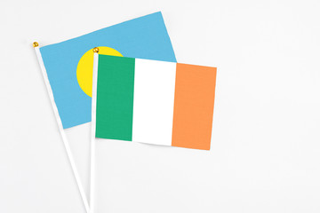 Ireland and Palau stick flags on white background. High quality fabric, miniature national flag. Peaceful global concept.White floor for copy space.