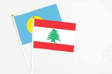 Lebanon and Palau stick flags on white background. High quality fabric, miniature national flag....