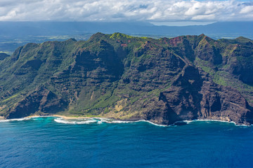 Aerial view of Kauai south coast showing mountains, beach and rugged coastline near Poipu Kauai Hawaii USA