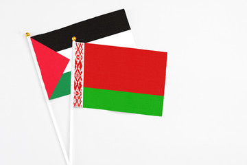 Belarus and Palestine stick flags on white background. High quality fabric, miniature national flag. Peaceful global concept.White floor for copy space.