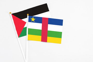 Central African Republic and Palestine stick flags on white background. High quality fabric, miniature national flag. Peaceful global concept.White floor for copy space.