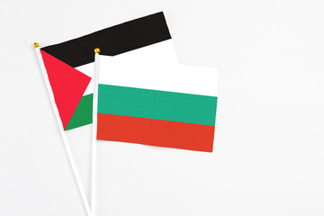 Bulgaria and Palestine stick flags on white background. High quality fabric, miniature national...
