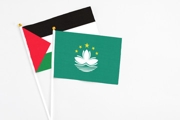 Macao and Palestine stick flags on white background. High quality fabric, miniature national flag. Peaceful global concept.White floor for copy space.