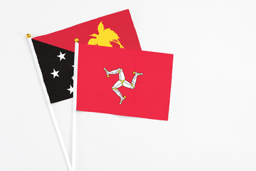 Isle Of Man and Papua New Guinea stick flags on white background. High quality fabric, miniature...