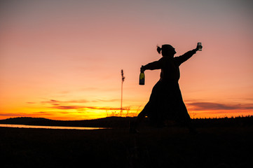silhouette of a girl dancing on the background of a beautiful sunset