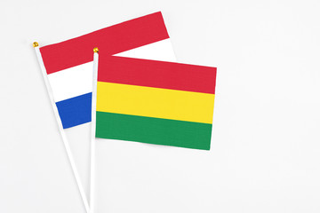 Bolivia and Paraguay stick flags on white background. High quality fabric, miniature national flag. Peaceful global concept.White floor for copy space.