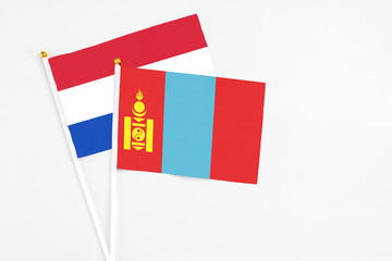 Mongolia and Paraguay stick flags on white background. High quality fabric, miniature national flag. Peaceful global concept.White floor for copy space.