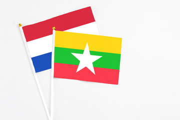 Myanmar and Paraguay stick flags on white background. High quality fabric, miniature national flag. Peaceful global concept.White floor for copy space.