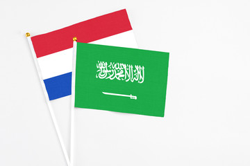 Saudi Arabia and Paraguay stick flags on white background. High quality fabric, miniature national flag. Peaceful global concept.White floor for copy space.