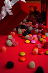 Colorful confectionery gift box on red background