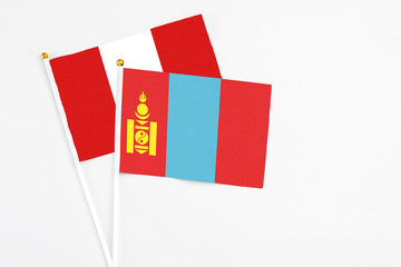 Mongolia and Peru stick flags on white background. High quality fabric, miniature national flag. Peaceful global concept.White floor for copy space.