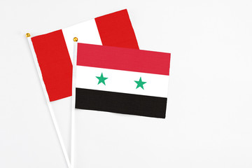 Syria and Peru stick flags on white background. High quality fabric, miniature national flag....
