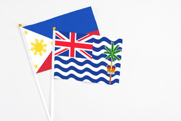 Fototapeta premium British Indian Ocean Territory and Philippines stick flags on white background. High quality fabric, miniature national flag. Peaceful global concept.White floor for copy space.