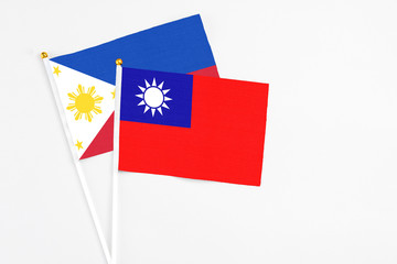 Taiwan and Philippines stick flags on white background. High quality fabric, miniature national flag. Peaceful global concept.White floor for copy space.
