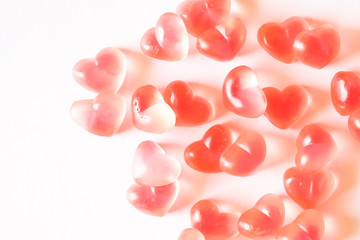 Pink heart shaped gummies background.
