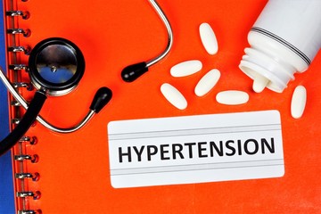 Medical folder with a diagnosis of hypertension. A stethoscope to listen to the patient, a...