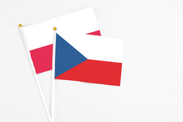 Czech Republic and Poland stick flags on white background. High quality fabric, miniature national flag. Peaceful global concept.White floor for copy space.