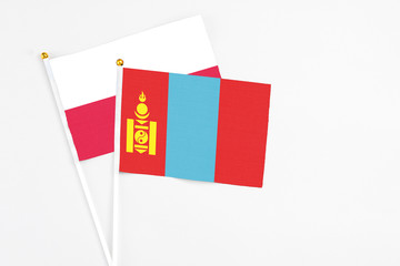 Mongolia and Poland stick flags on white background. High quality fabric, miniature national flag. Peaceful global concept.White floor for copy space.