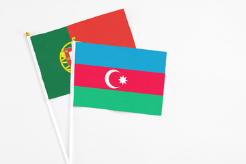 Azerbaijan and Portugal stick flags on white background. High quality fabric, miniature national flag. Peaceful global concept.White floor for copy space.