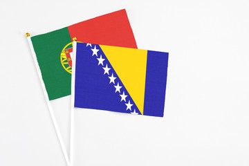 Bosnia Herzegovina and Portugal stick flags on white background. High quality fabric, miniature...