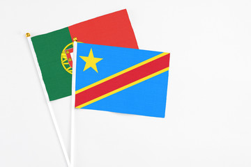 Congo and Portugal stick flags on white background. High quality fabric, miniature national flag. Peaceful global concept.White floor for copy space.