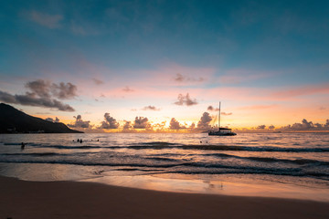 Beautiful view to catamaran boat in Seychelles bay during sunset travel to a tropical island and...