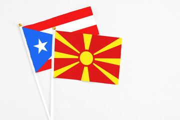 Macedonia and Puerto Rico stick flags on white background. High quality fabric, miniature national flag. Peaceful global concept.White floor for copy space.