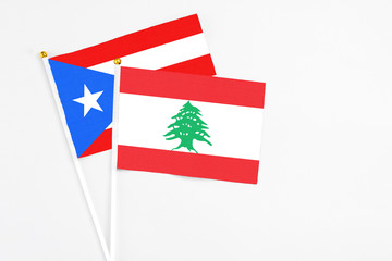 Lebanon and Puerto Rico stick flags on white background. High quality fabric, miniature national...