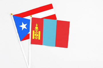 Mongolia and Puerto Rico stick flags on white background. High quality fabric, miniature national flag. Peaceful global concept.White floor for copy space.