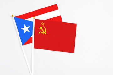 Soviet Union and Puerto Rico stick flags on white background. High quality fabric, miniature national flag. Peaceful global concept.White floor for copy space.