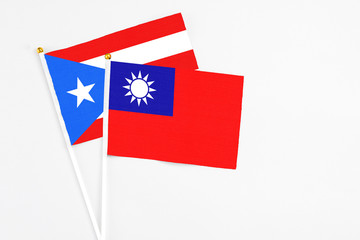 Taiwan and Puerto Rico stick flags on white background. High quality fabric, miniature national flag. Peaceful global concept.White floor for copy space.