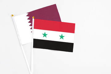 Syria and Qatar stick flags on white background. High quality fabric, miniature national flag....