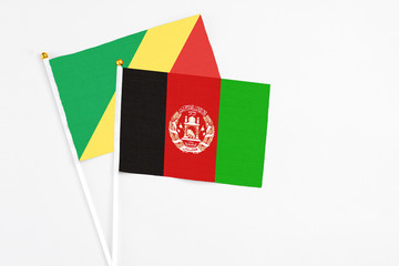 Afghanistan and Republic Of The Congo stick flags on white background. High quality fabric, miniature national flag. Peaceful global concept.White floor for copy space.