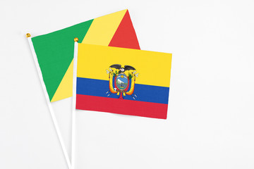 Ecuador and Republic Of The Congo stick flags on white background. High quality fabric, miniature national flag. Peaceful global concept.White floor for copy space.