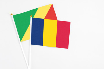 Chad and Republic Of The Congo stick flags on white background. High quality fabric, miniature national flag. Peaceful global concept.White floor for copy space.
