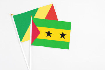 Sao Tome And Principe and Republic Of The Congo stick flags on white background. High quality fabric, miniature national flag. Peaceful global concept.White floor for copy space.