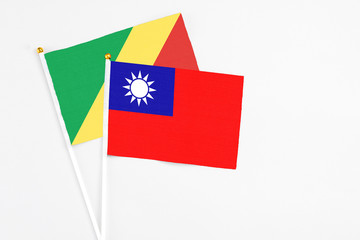 Taiwan and Republic Of The Congo stick flags on white background. High quality fabric, miniature national flag. Peaceful global concept.White floor for copy space.