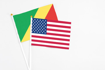 United States and Republic Of The Congo stick flags on white background. High quality fabric, miniature national flag. Peaceful global concept.White floor for copy space.